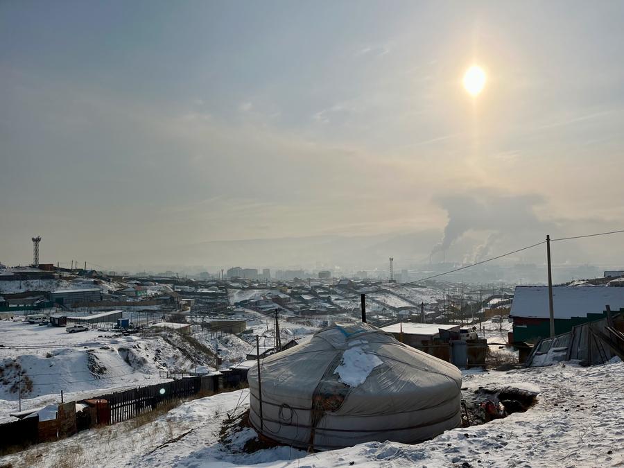 Plumes of smoke from Ulaanbaatar's coal-based power plants, as seen from a ger district area.