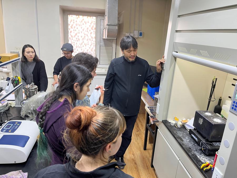 Professor Munkhbat Byambajav of the National University of Mongolia sharing information about new experiments with the molten salt thermal battery with MIT students.