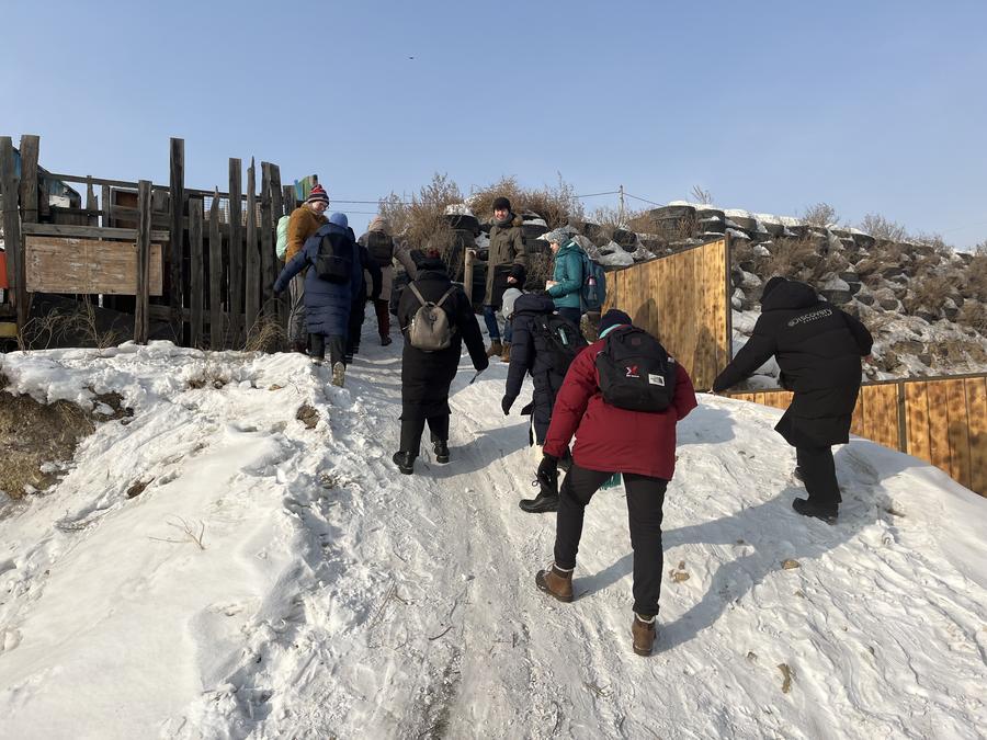 Going on an empathy walk to experience the steep and icy road and walkway conditions during the winter in the ger districts.